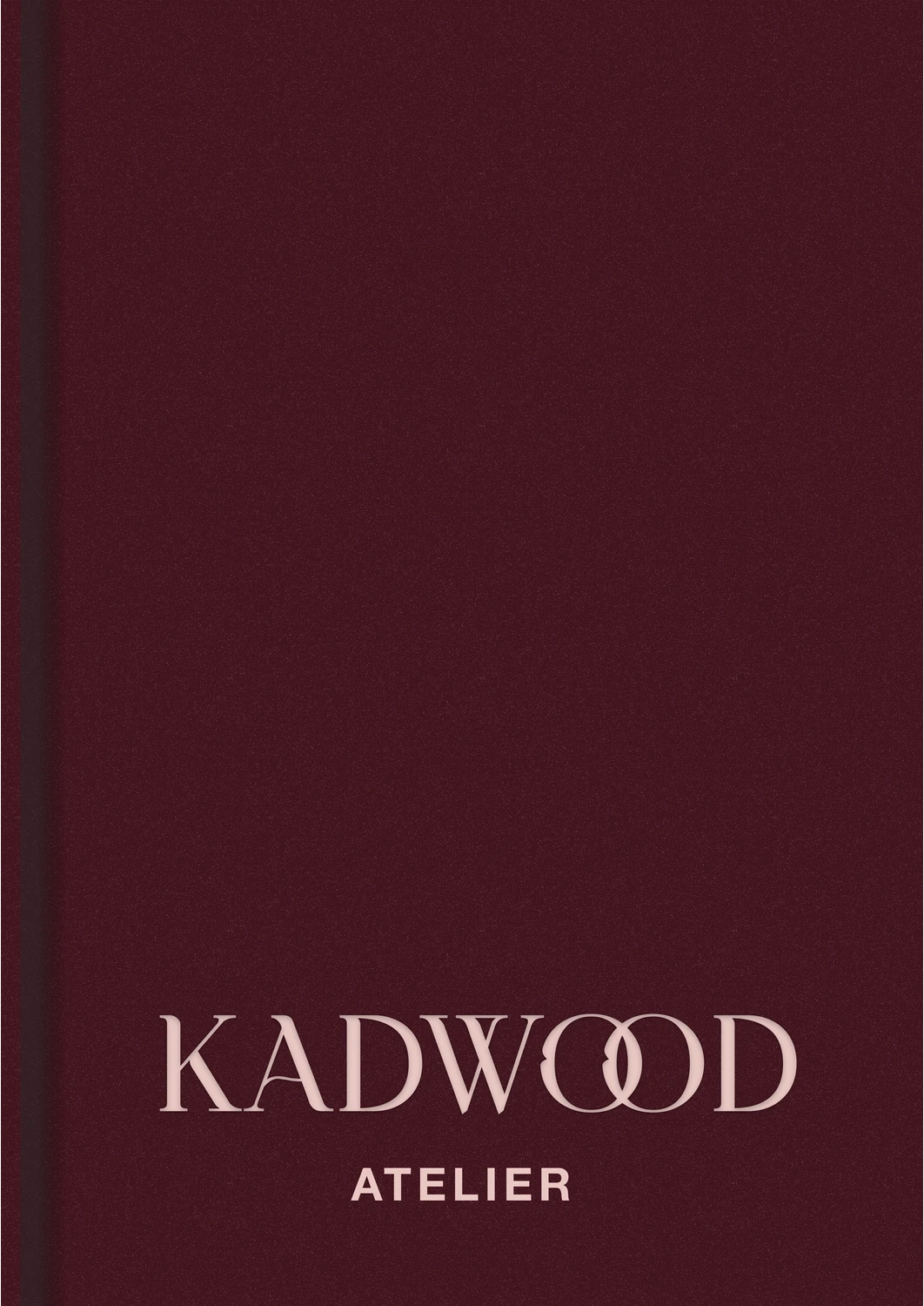 Kadwood Atelier's emblem, a promise etched in burgundy velvet, where geometric whispers unfold a world of sartorial dreams